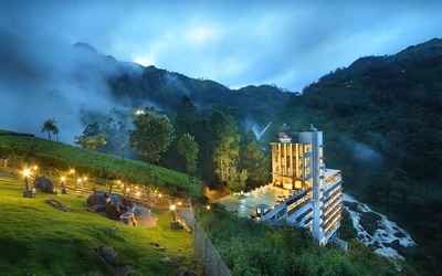 A cozy resort in Munnar set amidst scenic hills, surrounded by verdant tea plantations, mist-covered valleys, and a serene natural ambiance