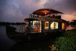 Anchored houseboat on the tranquil Alleppey backwaters, part of 4-day Kerala tour packages, Kerala, India.