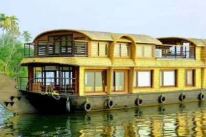 Scenic houseboat view in Alleppey backwaters featured in 9-day Kerala tour packages, Kerala