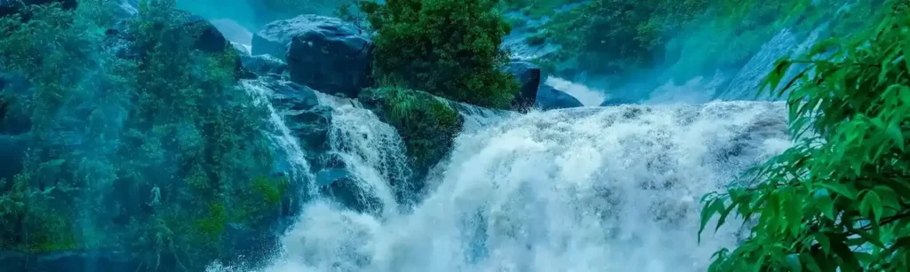 attukal waterfall munnar kerala tours Cascading Attukal Waterfalls surrounded by lush green tea hills in Munnar, Kerala